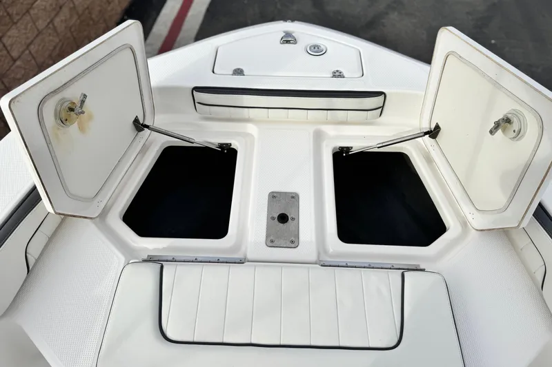 Slide: The Image of 2016 Yamaha Boats 190 FSH Deluxe open storage compartments on deck. - 14