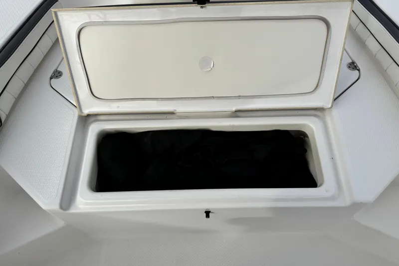 Slide: The Image of Open storage compartment on 2016 Yamaha Boats 190 FSH Deluxe. - 15