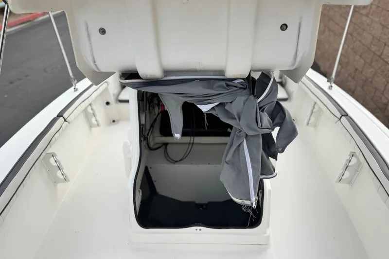 Slide: The Image of 2016 Yamaha Boats 190 FSH Deluxe storage compartment with open hatch and cover. - 17
