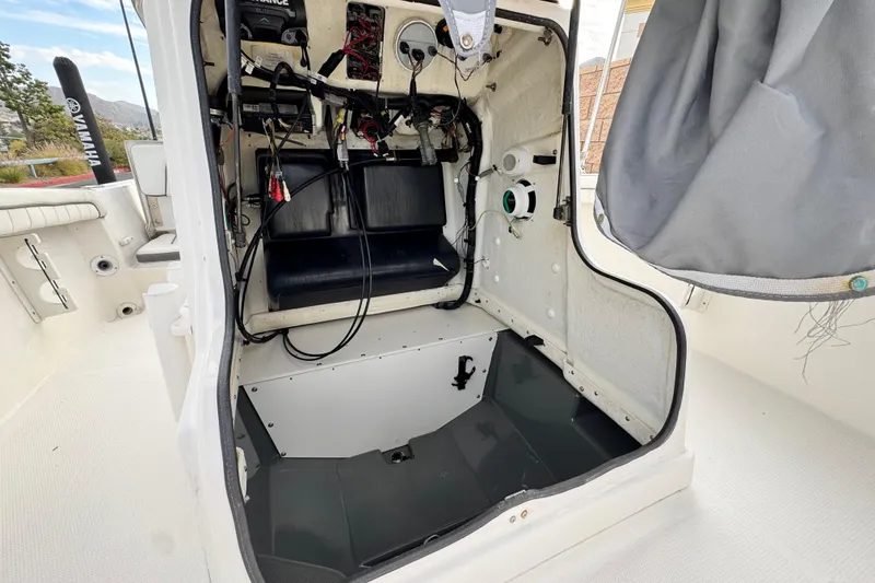 Slide: The Image of 2016 Yamaha Boats 190 FSH Deluxe interior wiring and storage compartment view. - 18
