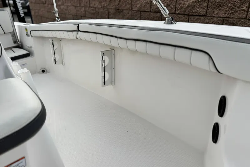 Slide: The Image of 2016 Yamaha Boats 190 FSH Deluxe interior with white cushioned seating and sleek design. - 19