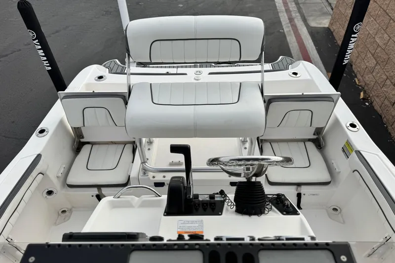 Slide: The Image of 2016 Yamaha Boats 190 FSH Deluxe interior with steering wheel and seating. - 21