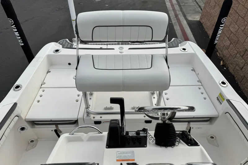 Slide: The Image of 2016 Yamaha Boats 190 FSH Deluxe interior with steering wheel and seating. - 22