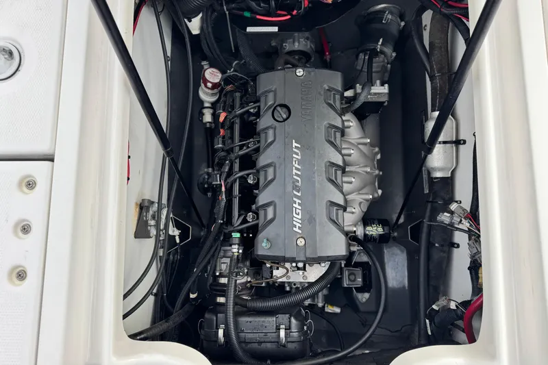 Slide: The Image of Engine compartment of a 2016 Yamaha Boats 190 FSH Deluxe, showcasing high output motor. - 24