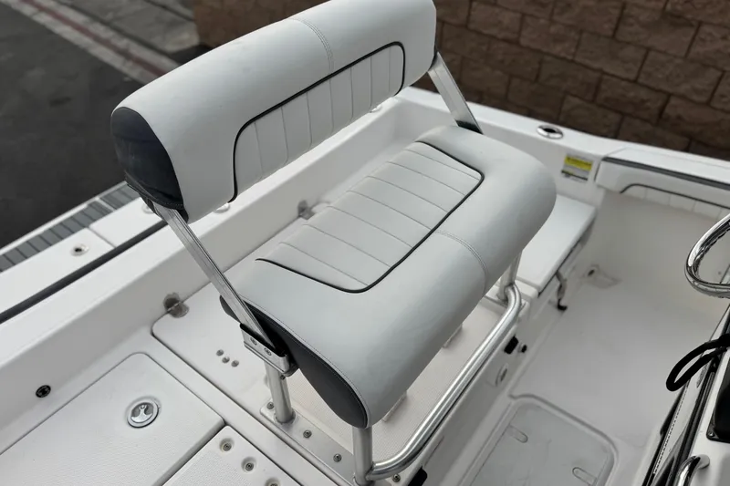 Slide: The Image of 2016 Yamaha Boats 190 FSH Deluxe seat, white and gray upholstery, sleek design. - 27