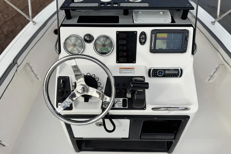 Slide: The Image of 2016 Yamaha Boats 190 FSH Deluxe dashboard with steering wheel and navigation controls. - 30