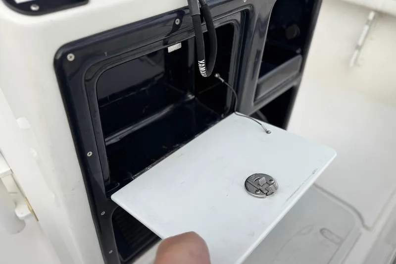 Slide: The Image of 2016 Yamaha Boats 190 FSH Deluxe storage compartment with open hatch. - 32