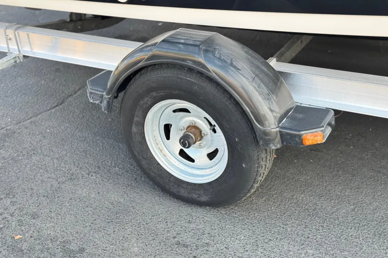 Slide: The Image of Trailer wheel of 2016 Yamaha Boats 190 FSH Deluxe on pavement. - 33