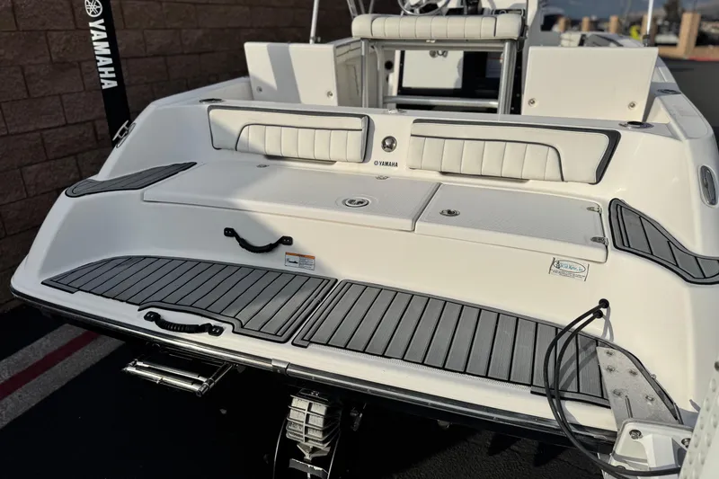 Slide: The Image of 2016 Yamaha Boats 190 FSH Deluxe, rear view, showcasing swim platform and seating. - 6