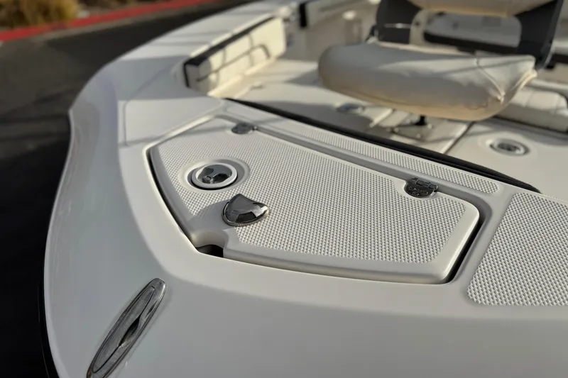 Slide: The Image of 2016 Yamaha Boats 190 FSH Deluxe deck, featuring seating and storage compartments. - 9