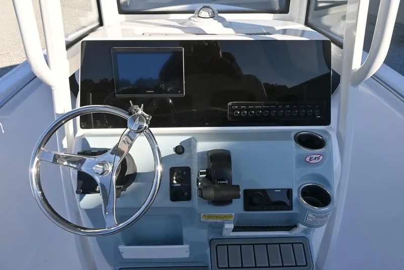 Slide: The Image of 2026 Tidewater 210 LXF boat dashboard with steering wheel and control panel. - 10
