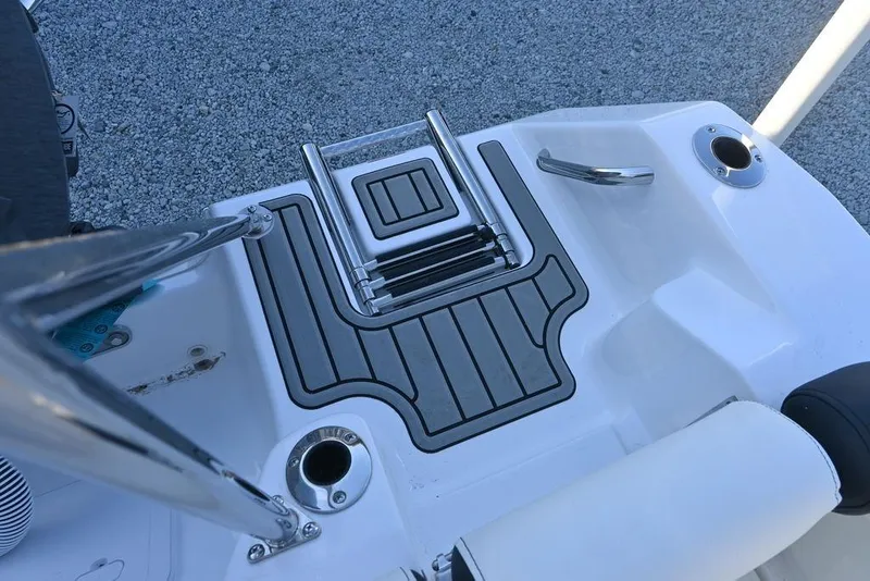 Slide: The Image of 2026 Tidewater 210 LXF boat deck with ladder and rod holders. - 11