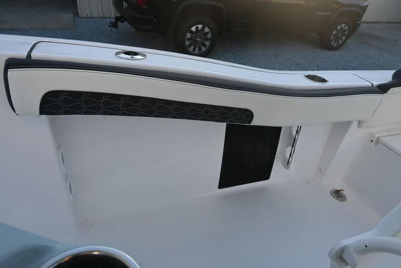 Slide: The Image of 2026 Tidewater 210 LXF boat interior detail with sleek design and cup holders. - 12