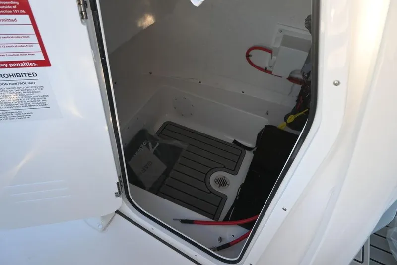 Slide: The Image of Interior view of 2026 Tidewater 210 LXF boat compartment with wiring and flooring. - 14