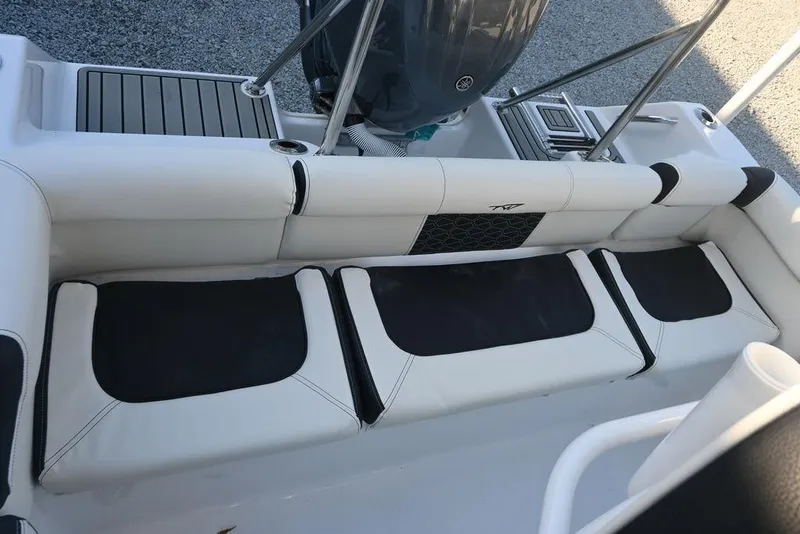 Slide: The Image of 2026 Tidewater 210 LXF boat interior with cushioned seating and sleek design. - 20