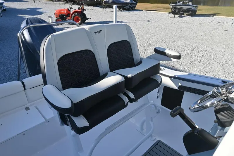 Slide: The Image of 2026 Tidewater 210 LXF boat interior with dual cushioned seats and steering wheel. - 4