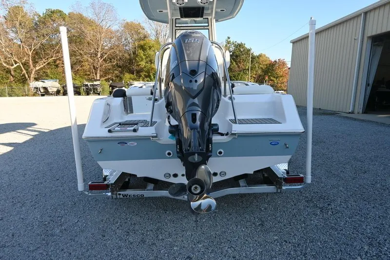 Slide: The Image of 2026 Tidewater 210 LXF boat with outboard motor on trailer, parked outdoors. - 5
