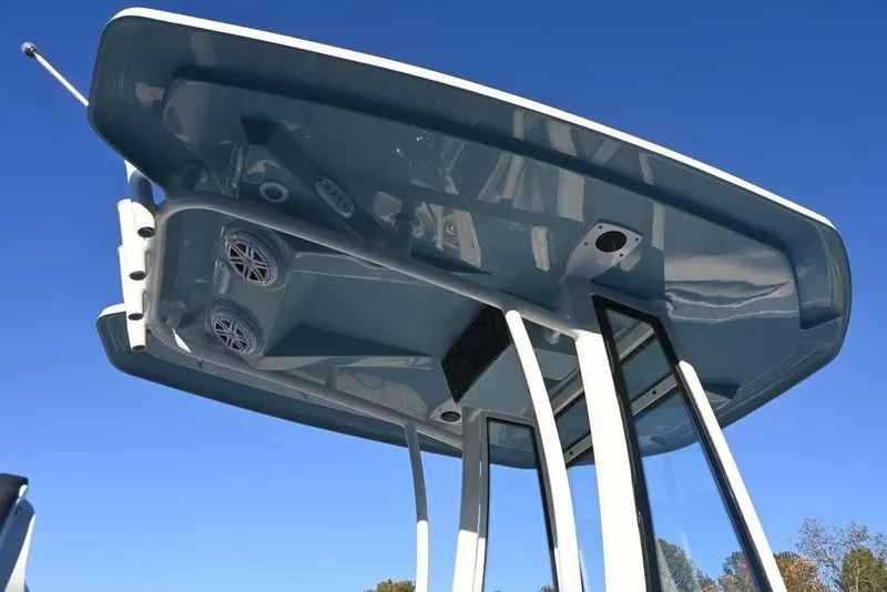 Slide: The Image of 2026 Tidewater 210 LXF boat T-top with speakers against clear blue sky. - 6
