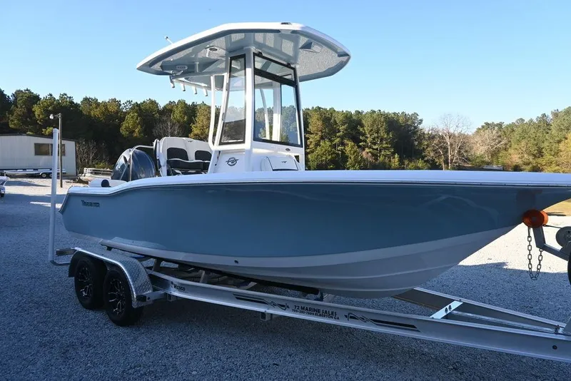 Slide: The Image of 2026 Tidewater 210 LXF boat on trailer, parked outdoors, with trees in the background. - 7