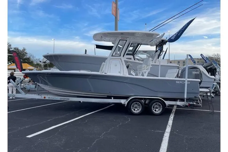 The Image of 2024 Sea Fox 231 Bay Fox boat on trailer in parking lot display. - 1