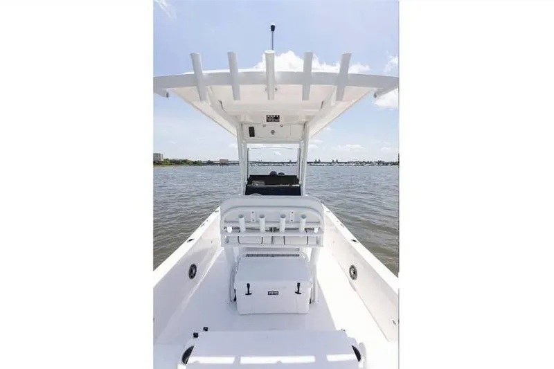 Slide: The Image of 2024 Sea Fox 231 Bay Fox boat on water, featuring center console and seating. - 11