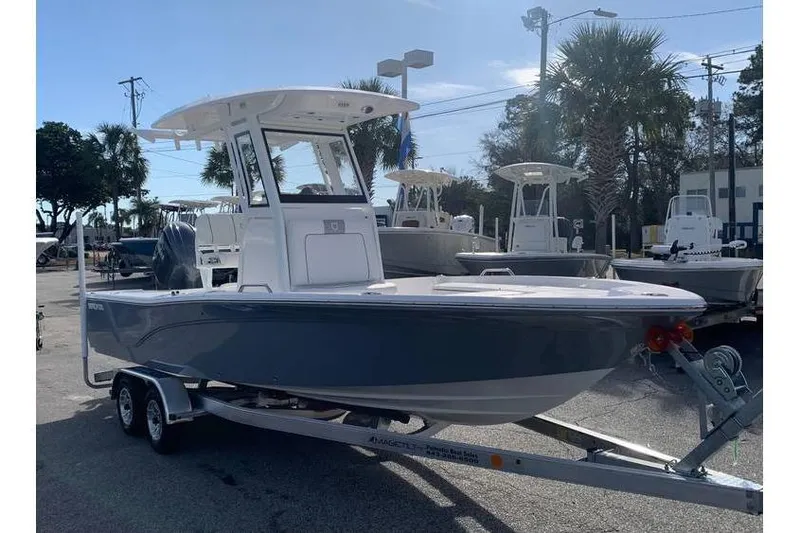 Slide: The Image of 2024 Sea Fox 231 Bay Fox boat on trailer, parked outdoors in a marina setting. - 13