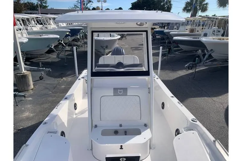 Slide: The Image of 2024 Sea Fox 231 Bay Fox boat displayed in a marina with other vessels. - 16