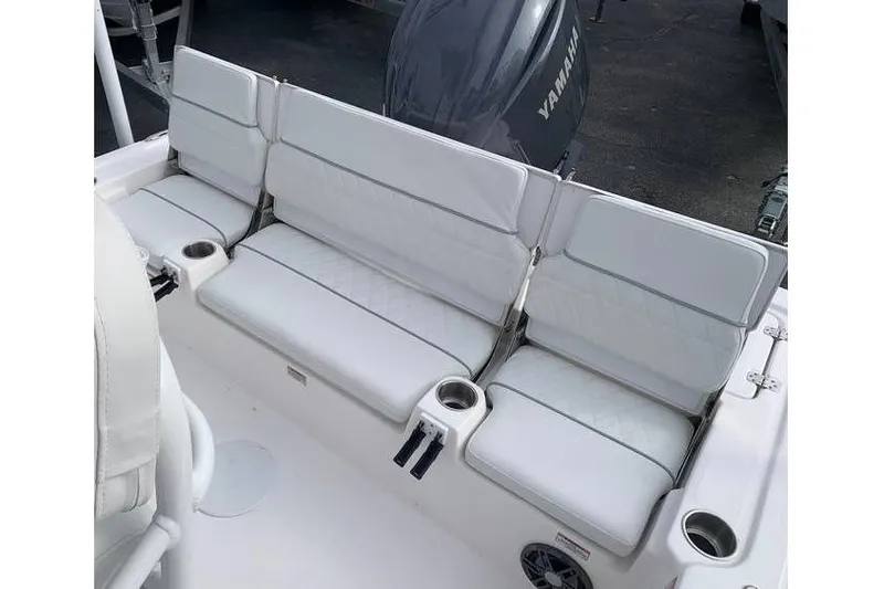 Slide: The Image of 2024 Sea Fox 231 Bay Fox boat seating with white cushions and cup holders. - 22
