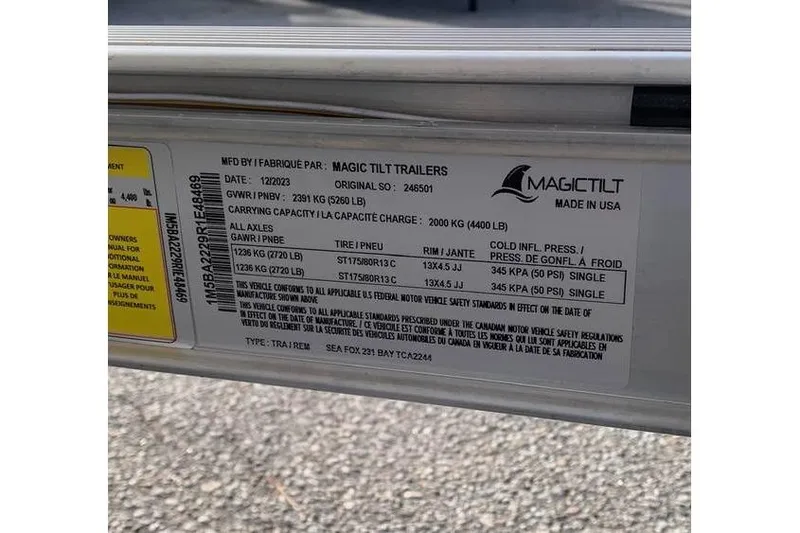 Slide: The Image of Label on Magic Tilt trailer for 2024 Sea Fox 231 Bay Fox, showing specifications and capacities. - 23