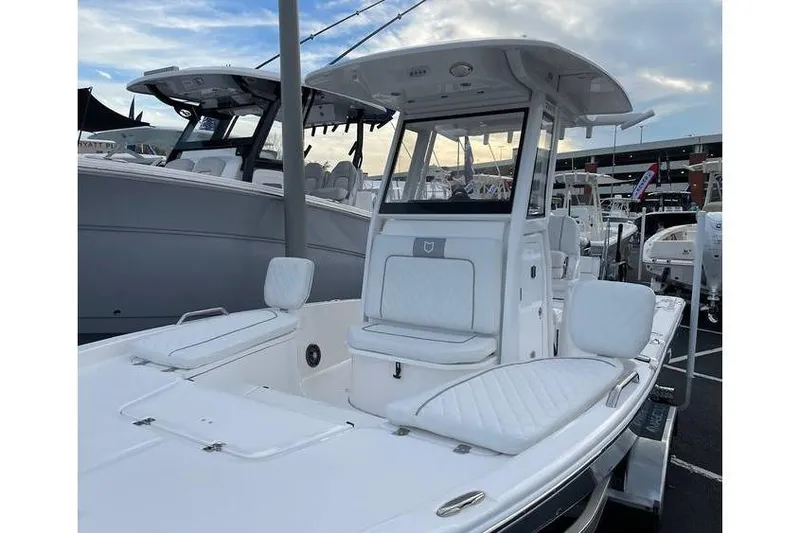 Slide: The Image of 2024 Sea Fox 231 Bay Fox boat with sleek white design at a marina. - 3