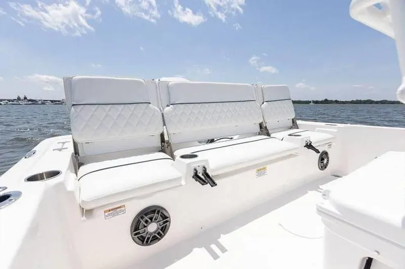 Slide: The Image of 2024 Sea Fox 231 Bay Fox boat interior with white seating and ocean view. - 5