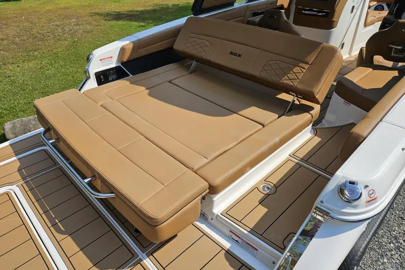 Slide: The Image of 2025 Chaparral 267 SSX boat with tan leather seating and spacious deck. - 10
