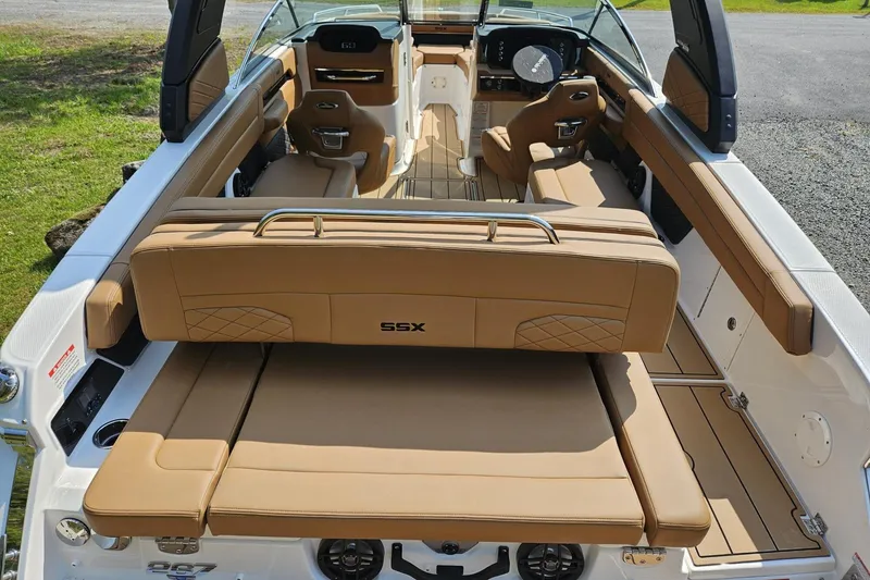 Slide: The Image of 2025 Chaparral 267 SSX boat interior with tan leather seating and modern design. - 11