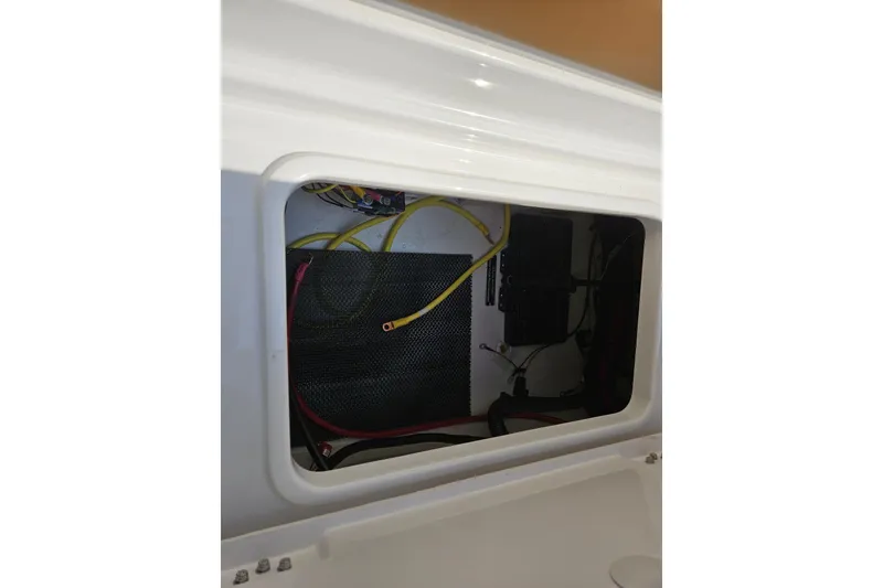 Slide: The Image of Electrical compartment of 2025 Chaparral 267 SSX boat with visible wiring. - 12