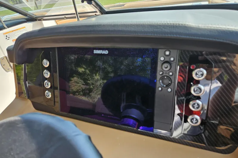 Slide: The Image of Dashboard of 2025 Chaparral 267 SSX boat featuring Simrad navigation system. - 13