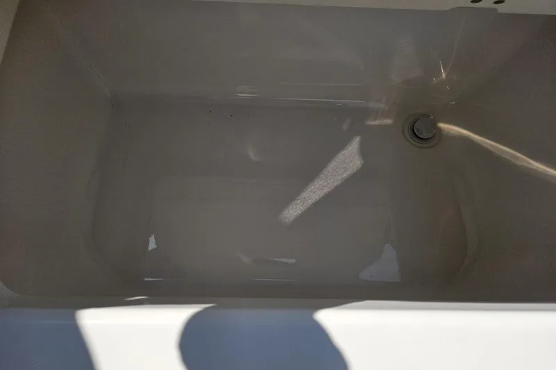 Slide: The Image of 2025 Chaparral 267 SSX boat storage compartment, empty and clean. - 14