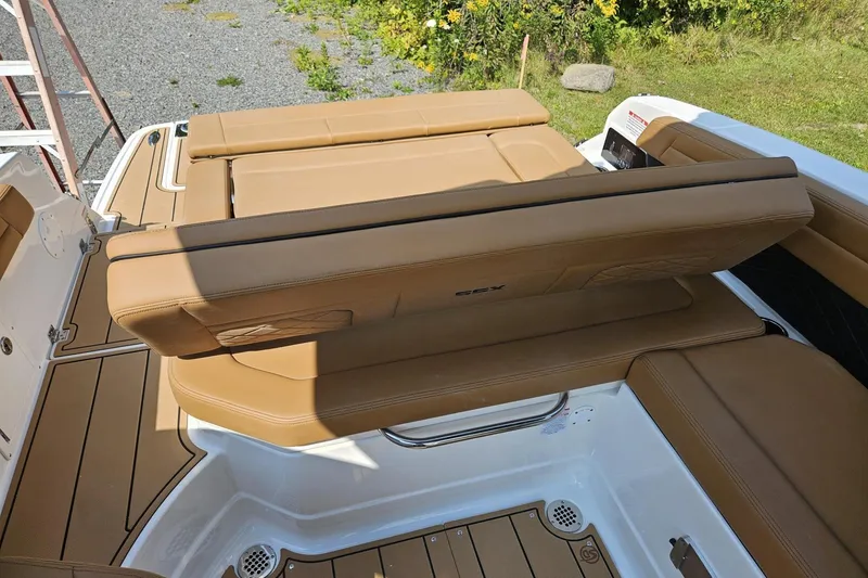 Slide: The Image of 2025 Chaparral 267 SSX boat with tan leather seating and teak-style flooring. - 16