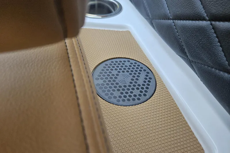 Slide: The Image of 2025 Chaparral 267 SSX interior detail with wireless charging pad and luxurious seating. - 20