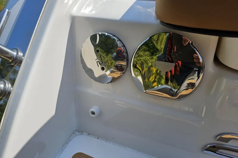Slide: The Image of Chrome fittings on a 2025 Chaparral 267 SSX boat, reflecting surroundings. - 22