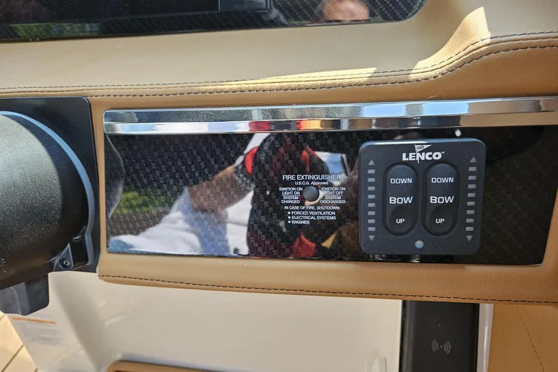 Slide: The Image of Control panel of 2025 Chaparral 267 SSX boat with Lenco trim tab switches. - 23