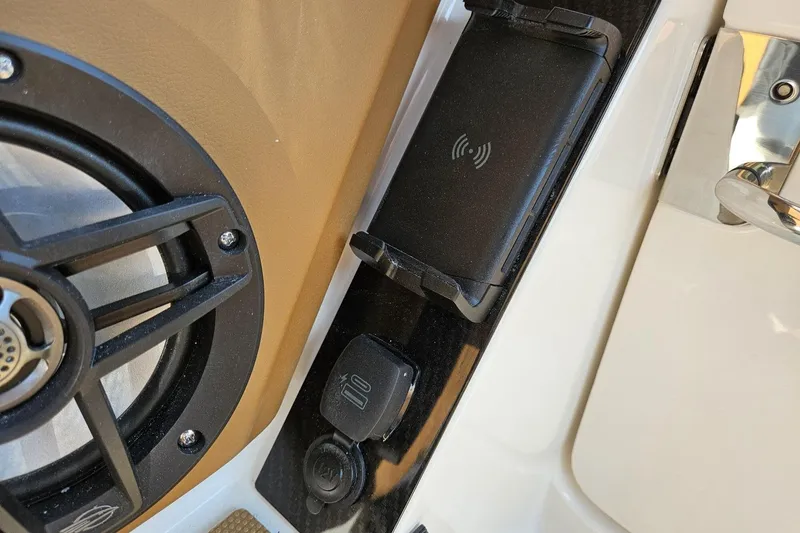 Slide: The Image of 2025 Chaparral 267 SSX boat interior with speaker and wireless charging pad. - 28