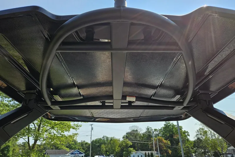 Slide: The Image of 2025 Chaparral 267 SSX boat canopy viewed from below, showcasing sturdy construction. - 31