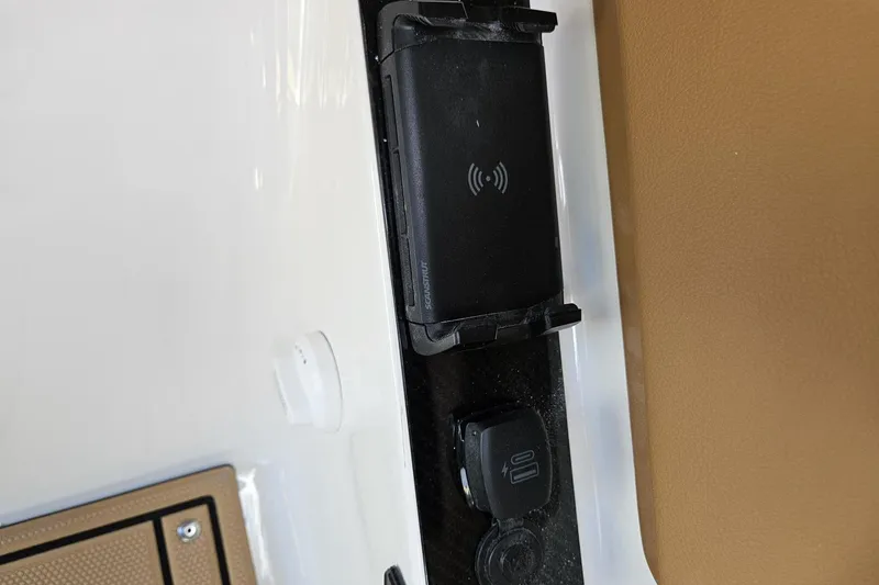 Slide: The Image of 2025 Chaparral 267 SSX boat wireless charging station and USB port detail. - 36