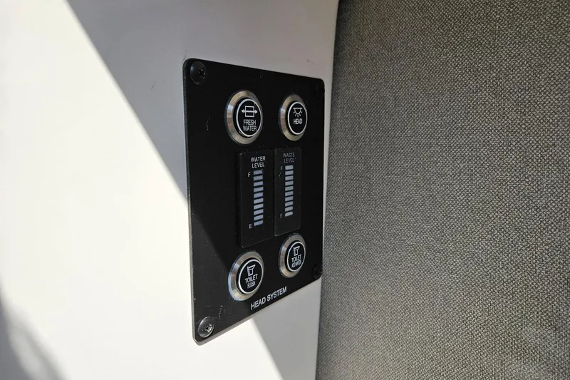 Slide: The Image of Control panel on 2025 Chaparral 267 SSX boat, showing water and waste levels. - 37