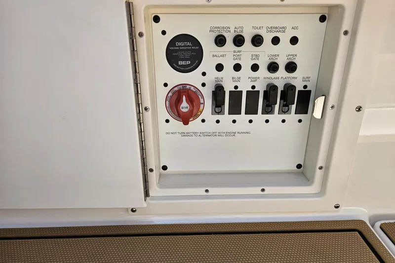 Slide: The Image of Control panel of 2025 Chaparral 267 SSX boat with switches and battery dial. - 39