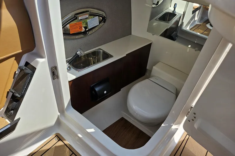 Slide: The Image of 2025 Chaparral 267 SSX boat interior bathroom with sink and toilet. - 41