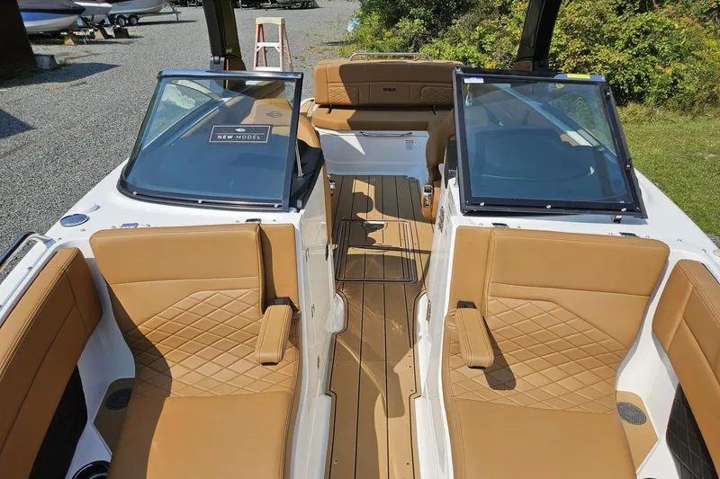 Slide: The Image of 2025 Chaparral 267 SSX boat interior with tan leather seating and modern design. - 7