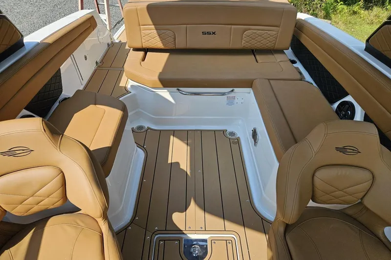 Slide: The Image of 2025 Chaparral 267 SSX boat interior with tan leather seating and teak-style flooring. - 9