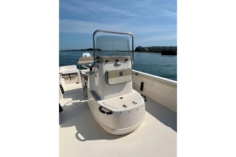 Slide: The Image of 2023 Carolina Skiff 21 LS boat on water, featuring center console and open deck. - 12