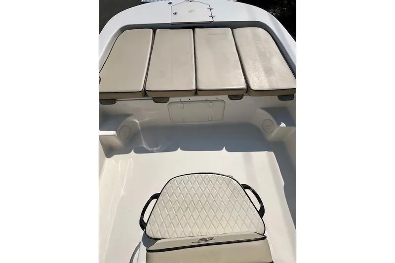 Slide: The Image of 2023 Carolina Skiff 21 LS boat interior with cushioned seating and storage compartments. - 13